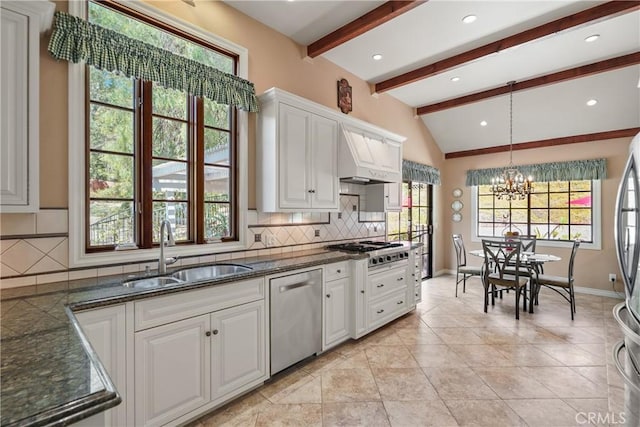 kitchen with vaulted ceiling with beams, stainless steel appliances, a sink, white cabinets, and dark countertops