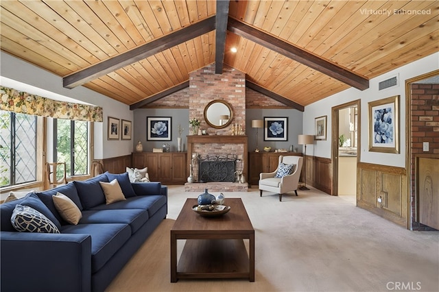 living area with wooden ceiling, a brick fireplace, visible vents, and wainscoting