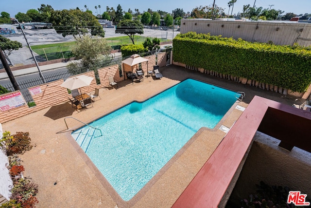 view of swimming pool featuring a patio area