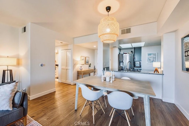 850 E Ocean Blvd Unit 613, Long Beach, CA 90802 - dining room featuring baseboards and wood finished floors