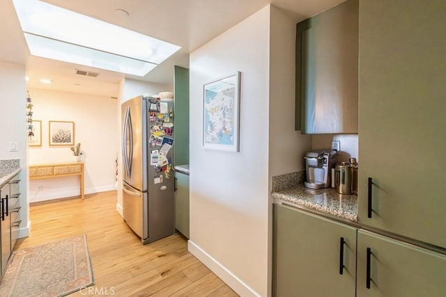 850 E Ocean Blvd Unit 613, Long Beach, CA 90802 - kitchen with freestanding refrigerator, light wood-style flooring, and baseboards