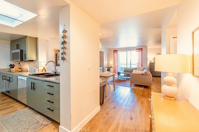 850 E Ocean Blvd Unit 613, Long Beach, CA 90802 - kitchen featuring a sink, stainless steel appliances, light wood-style flooring, and light countertops