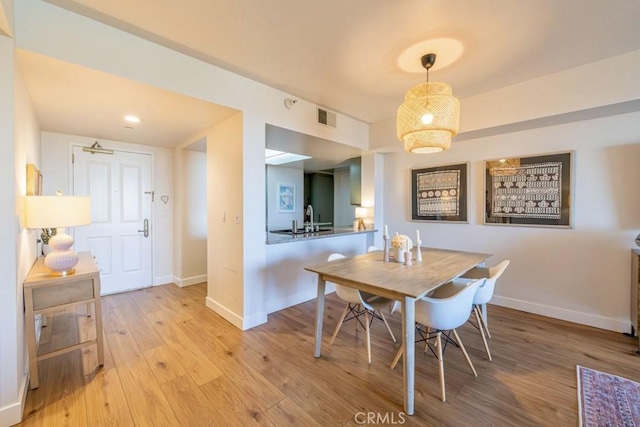 850 E Ocean Blvd Unit 613, Long Beach, CA 90802 - dining room with baseboards and light wood finished floors