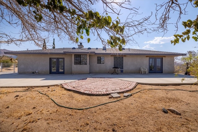 rear view of house with french doors and a patio