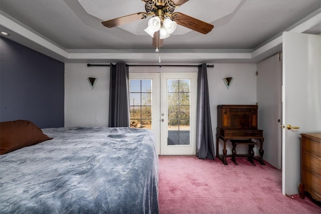 carpeted bedroom with french doors, access to outside, a raised ceiling, and ceiling fan