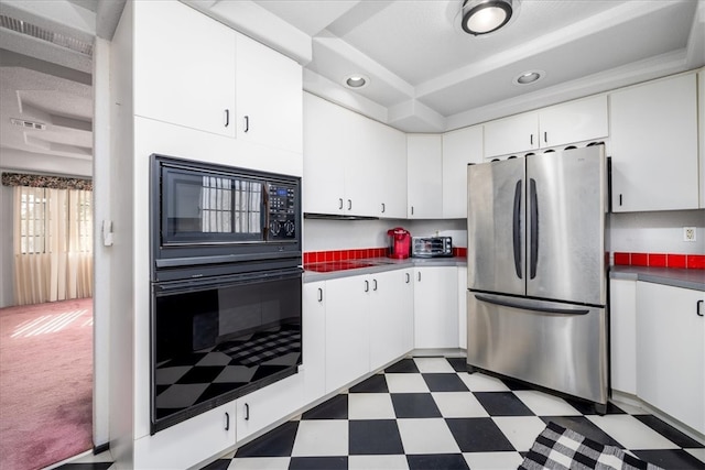 kitchen with black appliances and white cabinets