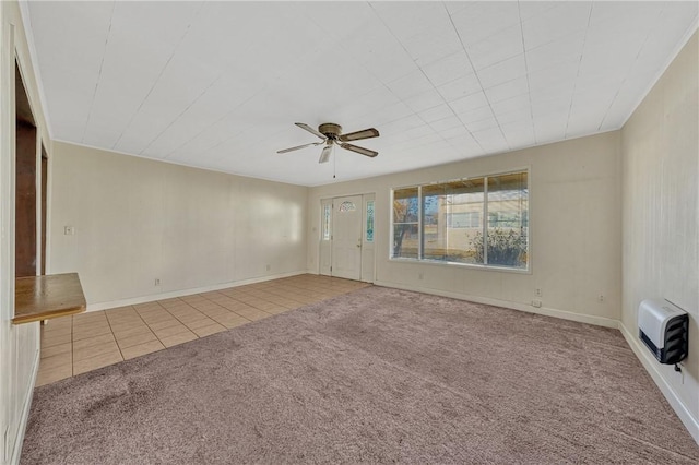 carpeted spare room with ceiling fan and heating unit