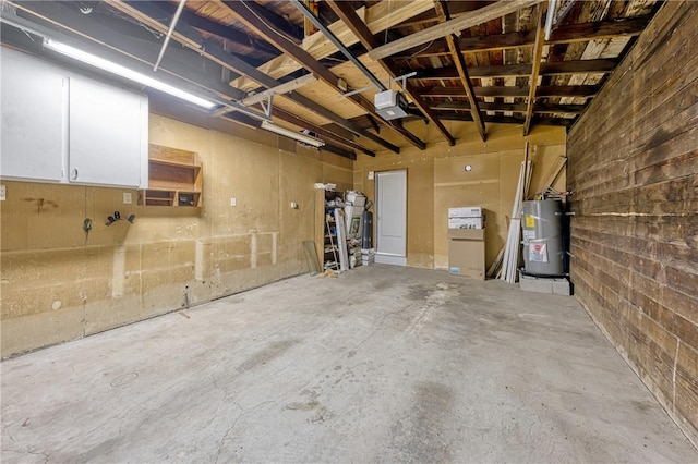 garage featuring secured water heater and a garage door opener