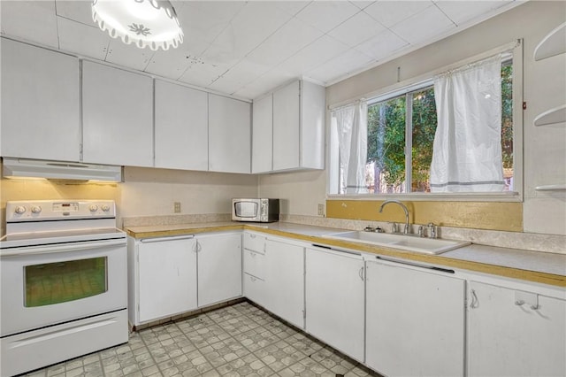 kitchen with sink, white cabinets, and white electric stove