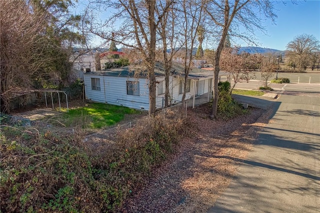 view of property exterior with a mountain view