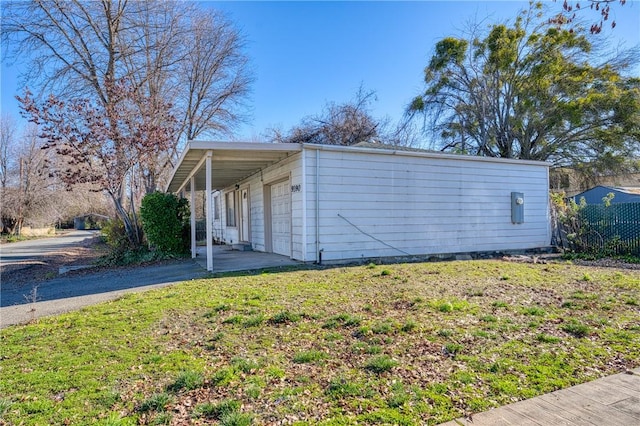 view of side of home featuring a lawn