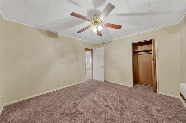 unfurnished bedroom featuring carpet flooring, ceiling fan, and a closet