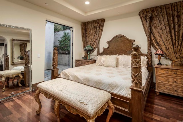 bedroom with access to outside and dark hardwood / wood-style floors