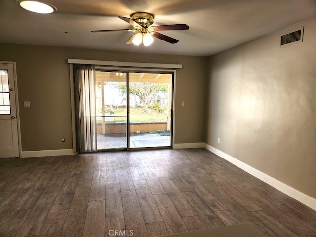 spare room with dark hardwood / wood-style floors and ceiling fan