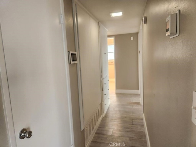 hallway with light hardwood / wood-style flooring