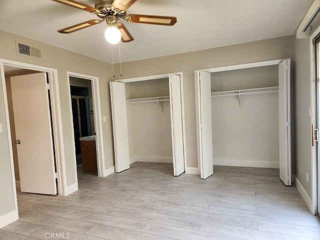 unfurnished bedroom featuring multiple closets, ceiling fan, and light wood-type flooring