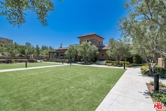 surrounding community with a yard and a pergola