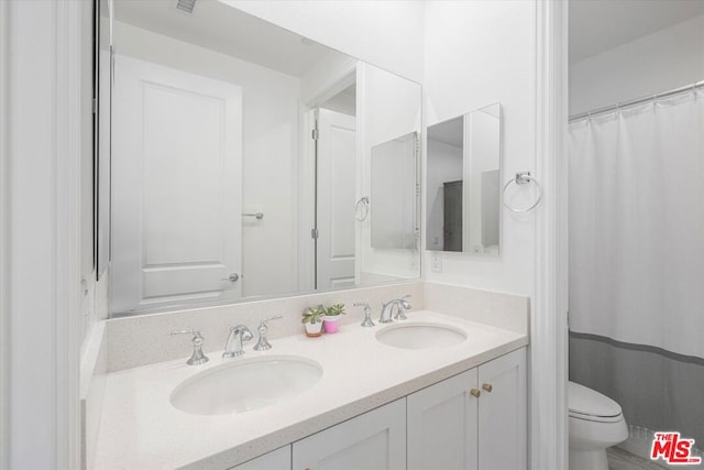 bathroom featuring toilet and vanity