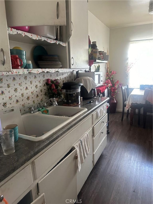 kitchen with sink and dark wood-type flooring