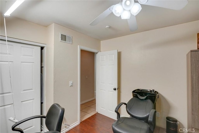 office with ceiling fan and dark wood-type flooring