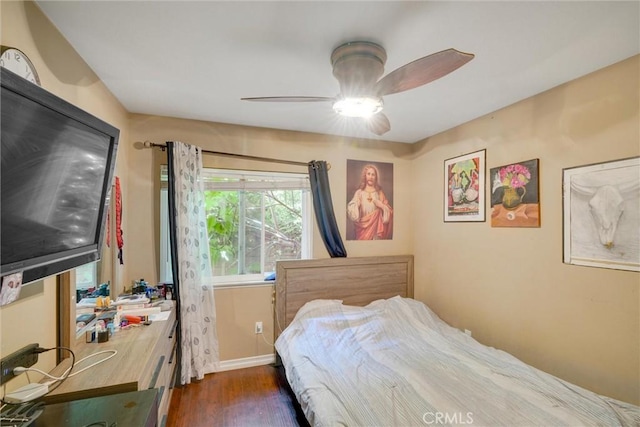 bedroom with ceiling fan and dark hardwood / wood-style floors