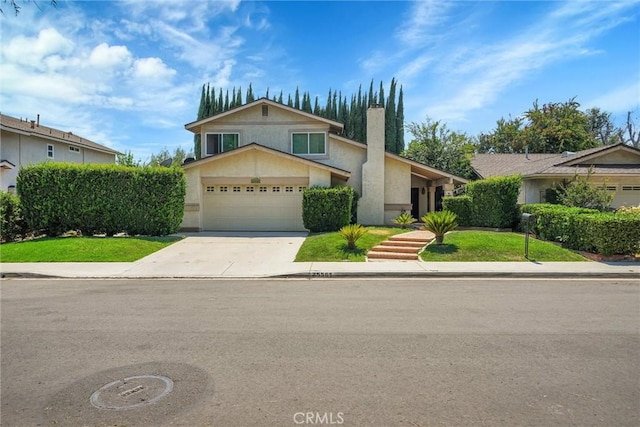 view of front of property with a front yard and a garage