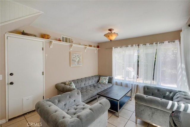 tiled living room with a healthy amount of sunlight