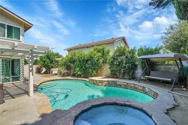 view of pool with a patio area and an in ground hot tub