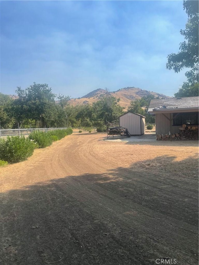 6009 Elwood Rd, Sanger, CA 93657 - view of yard with a mountain view, an outdoor structure, and a pole building