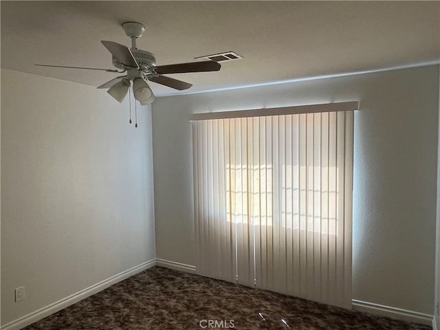 carpeted spare room featuring ceiling fan