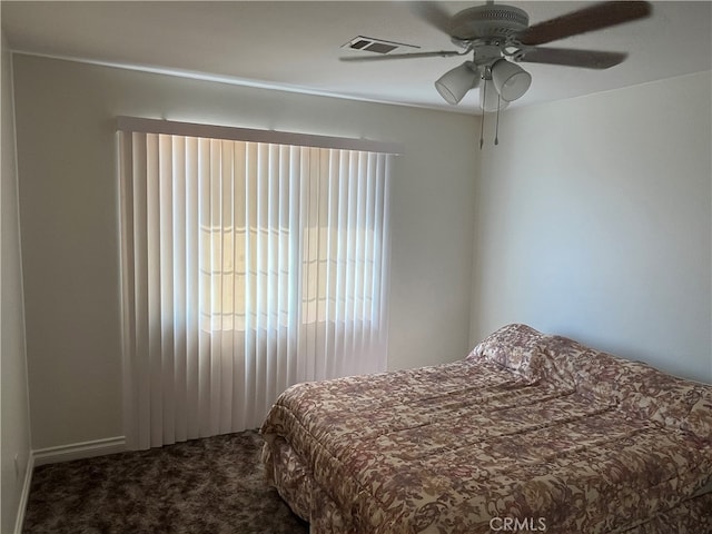 bedroom featuring multiple windows, carpet floors, and ceiling fan