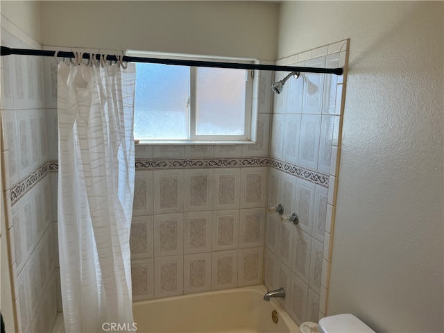 bathroom with shower / tub combo with curtain