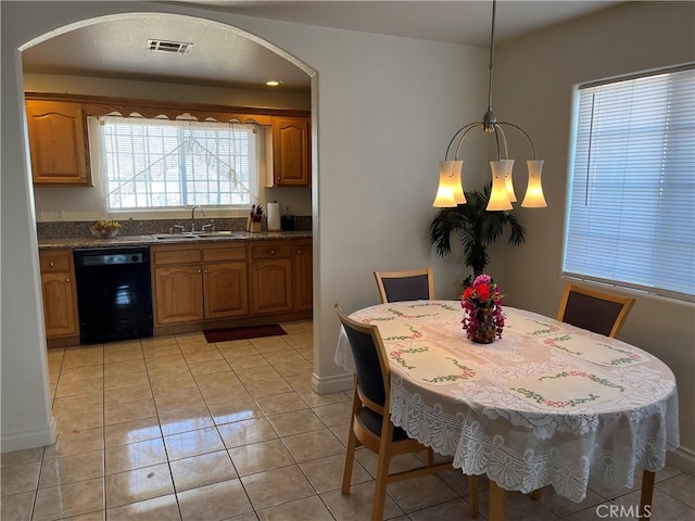 dining space featuring an inviting chandelier, visible vents, light tile patterned floors, arched walkways, and baseboards