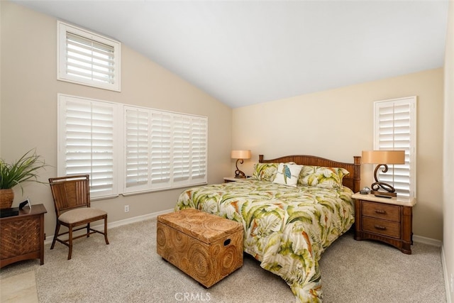 carpeted bedroom featuring lofted ceiling