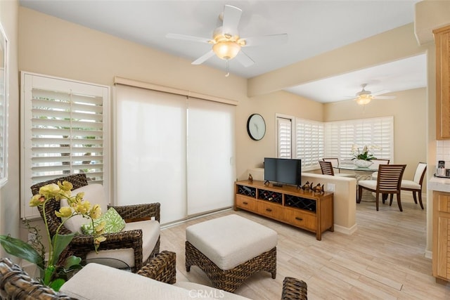 living room featuring ceiling fan and light wood-type flooring