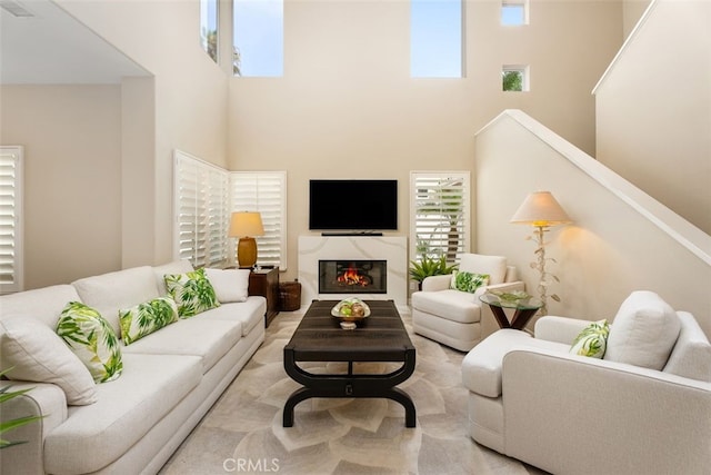 living room with a high ceiling and a wealth of natural light