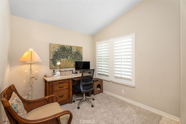 carpeted office with lofted ceiling