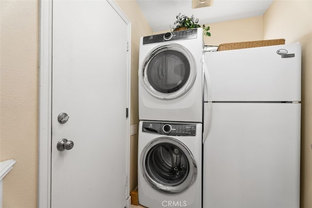 laundry room featuring stacked washer / dryer