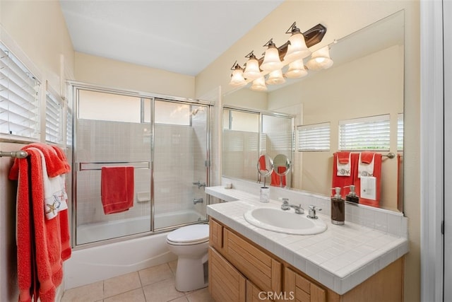 full bathroom featuring tile patterned flooring, vanity, toilet, and enclosed tub / shower combo