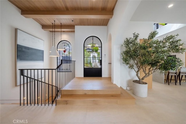 foyer featuring wood ceiling, beamed ceiling, and a healthy amount of sunlight