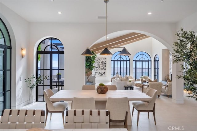 dining area featuring beamed ceiling