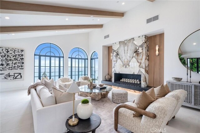 living room featuring beamed ceiling, a premium fireplace, radiator heating unit, and high vaulted ceiling