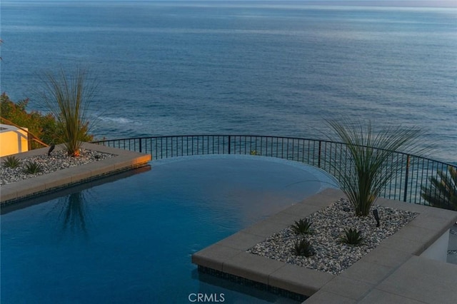 view of pool featuring a water view