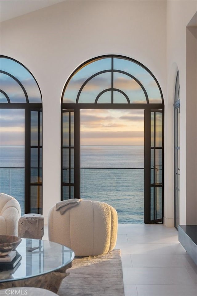 dining area with a water view, a healthy amount of sunlight, and lofted ceiling