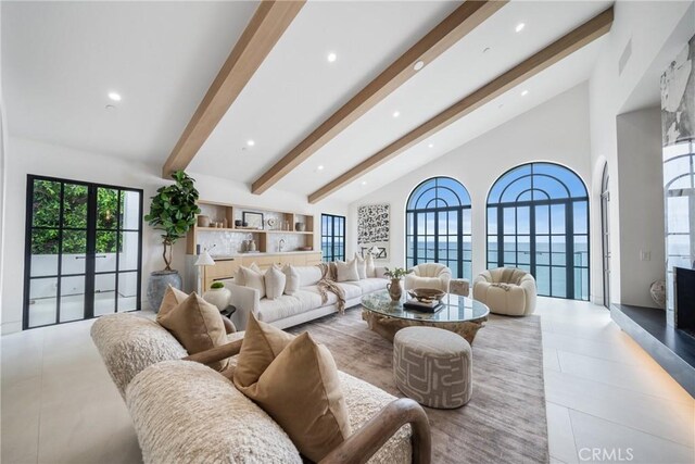 living room featuring beamed ceiling, high vaulted ceiling, and french doors