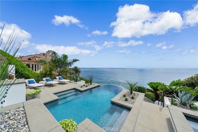 view of pool featuring a jacuzzi, a water view, and a patio area