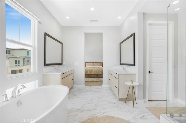 bathroom featuring vanity and a bath