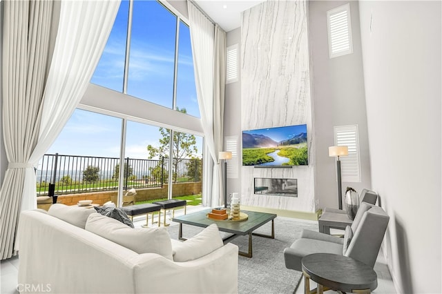 living room featuring a towering ceiling and plenty of natural light