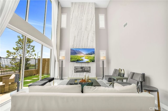 living room with a high ceiling and plenty of natural light