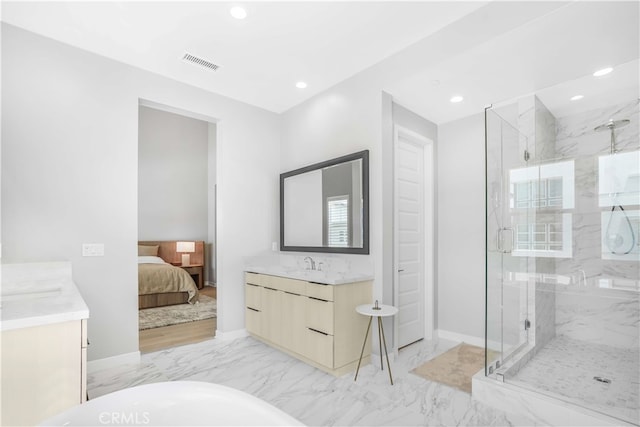 bathroom with walk in shower and vanity